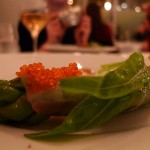 asparagus spear wrapped in lardo with flying fish eggs and a slice of kumquat at La Bigarrade by Meg Zimbeck