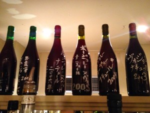 Japanese clients sign bottles of Nouveau at Café de la Nouvelle Mairie