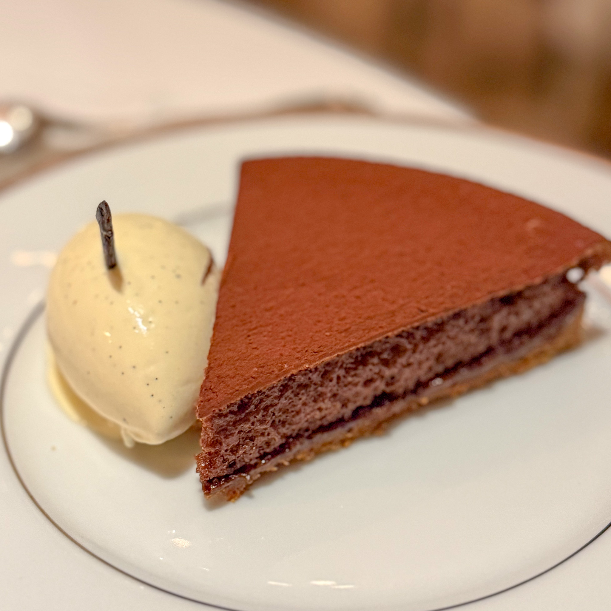 Dark chocolate tart with vanilla ice cream | PARIS BY MOUTH Dark chocolate tart with vanilla ice cream at L'Ambroisie restaurant in Paris