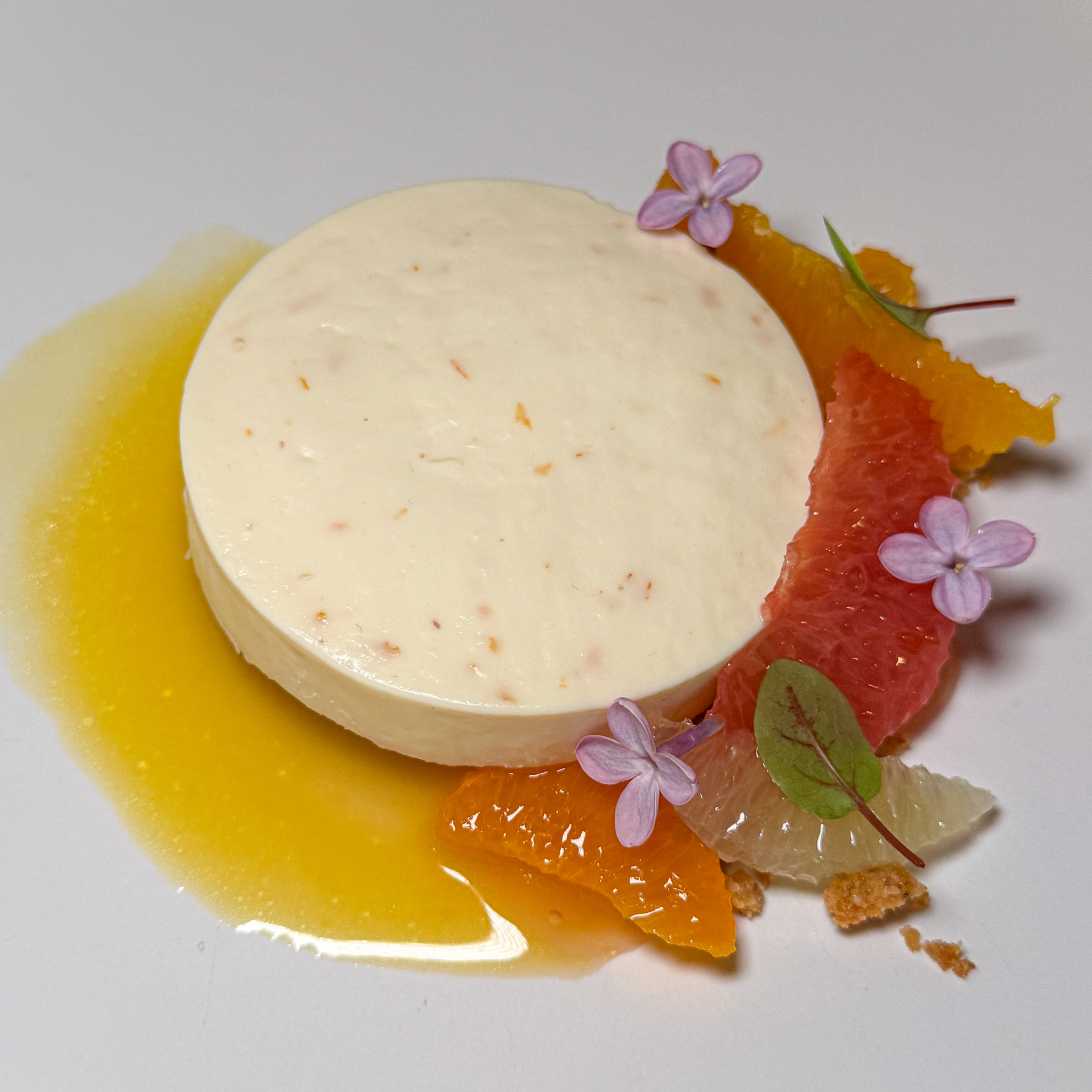 A citrus-and-fennel mousse ringed with orange and grapefruit segments and purple blossoms