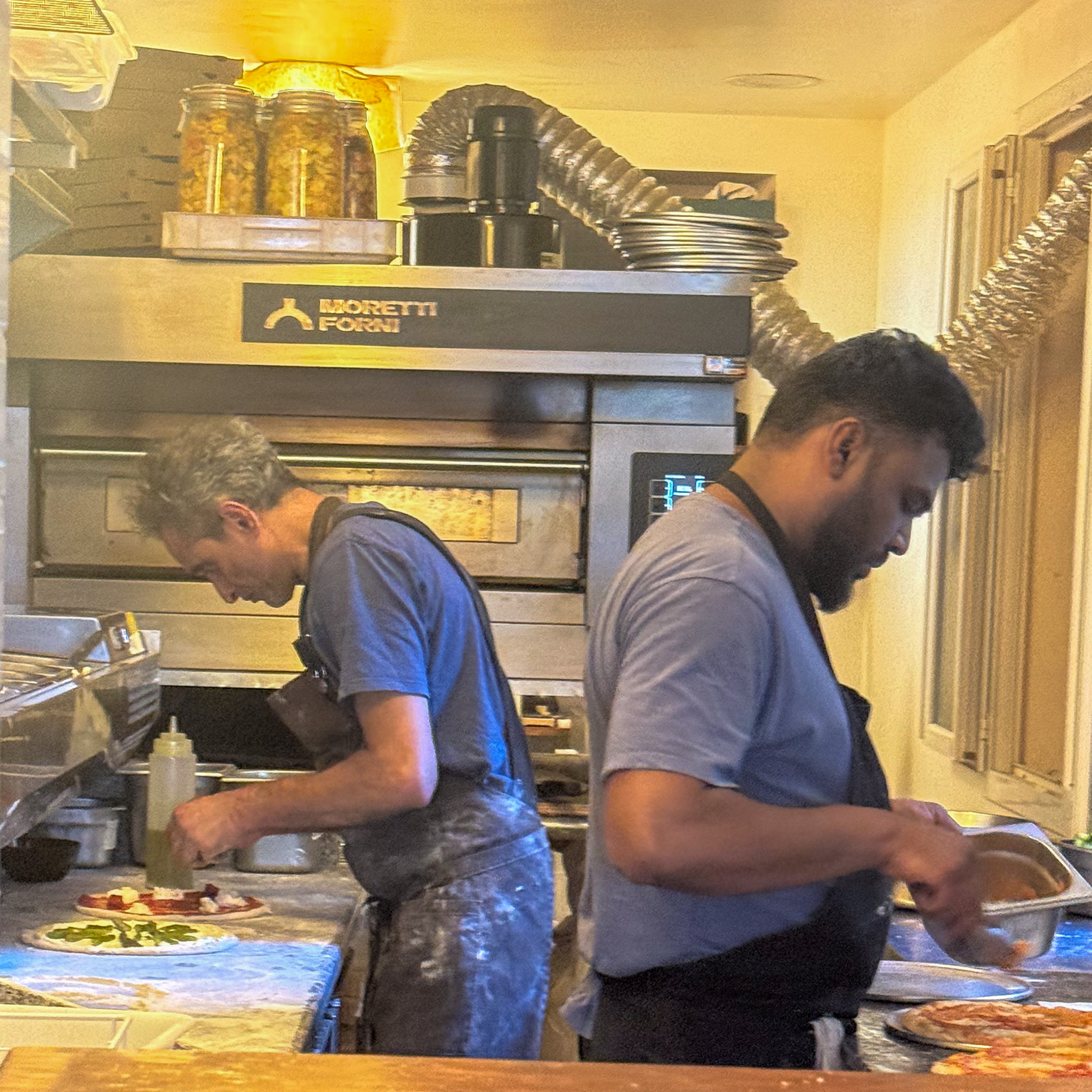 Two pizzaioli working the counter and Moretti Forni oven at Acid Lactic, 11th arrondissement, Paris