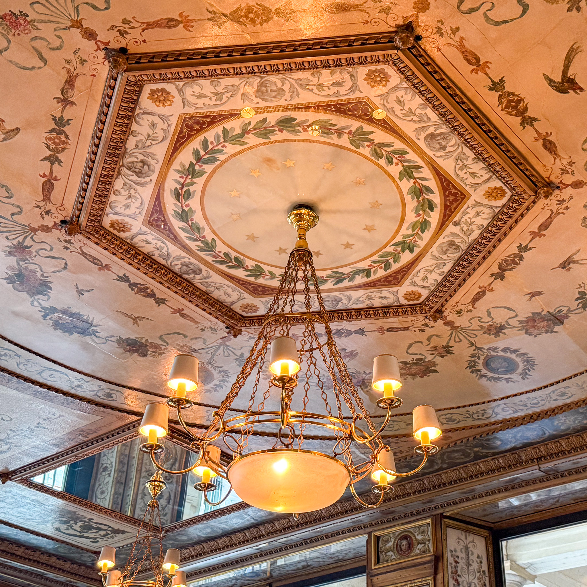 ceiling-le-grand-vefour-restaurant-paris | PARIS BY MOUTH The candlelit Directoire dining room at Le Grand Véfour, with teal-blue velvet banquettes and gilt-framed mirrors.