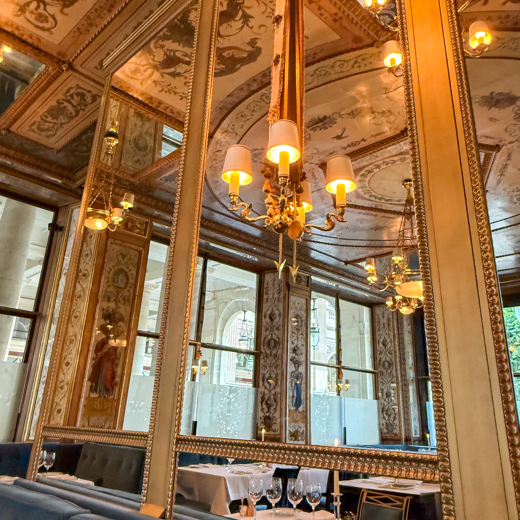 interior-le-grand-vefour-restaurant-paris | PARIS BY MOUTH The candlelit Directoire dining room at Le Grand Véfour, with gilt-framed mirrors.