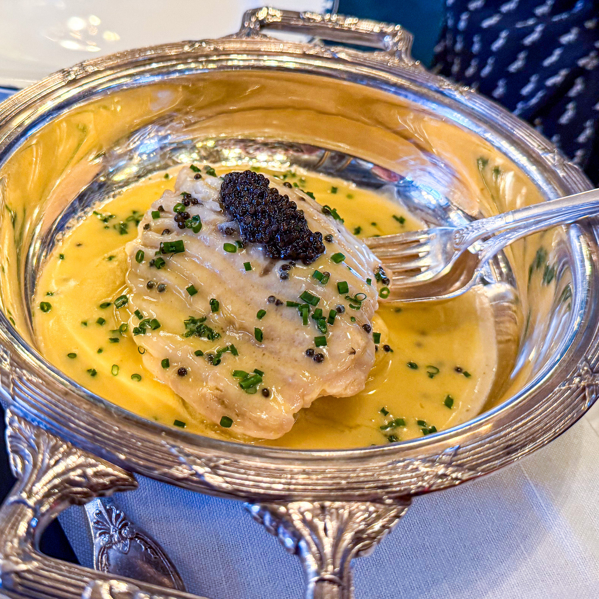 skate-wing-caviar-le-grand-vefour-restaurant-paris | PARIS BY MOUTH Skate wing with a quenelle of caviar over potatoes in a silver dish at Le Grand Véfour.